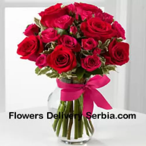 19 Red Roses With Seasonal Fillers In A Glass Vase Decorated With A Pink Bow