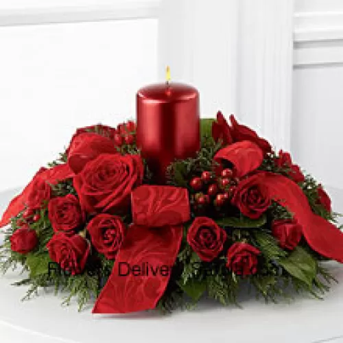 A crimson display of holiday warmth and cheer. Rich red roses and spray roses, red hypericum berries and lush holiday greens encircle a red metallic pillar candle to create a heart-warming centerpiece. Bedecked with bright red ribbon, this design will bring the spirit of the holiday season to their gatherings and celebrations with style and grace.  (Please Note That We Reserve The Right To Substitute Any Product With A Suitable Product Of Equal Value In Case Of Non-Availability Of A Certain Product)